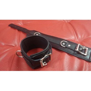 A pair of high quality black leather handcuffs with metal loops​