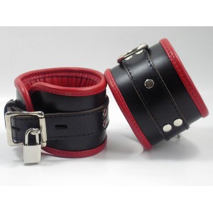 Wide handcuffs are made of premium black leather combined with red