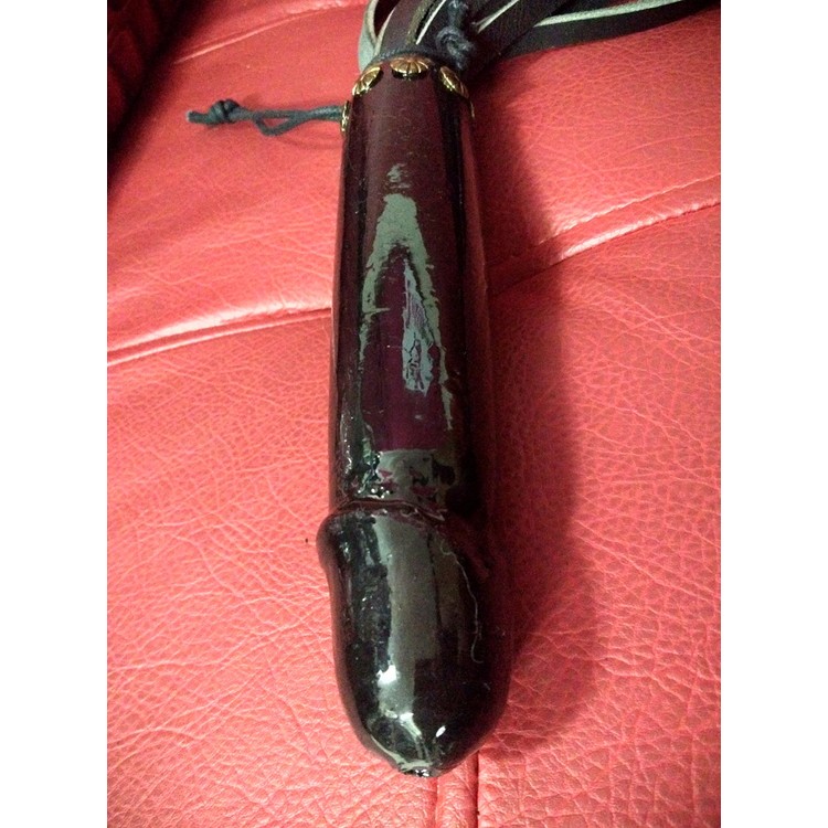 Flogger made of high quality leather with a wooden handle in the shape of a penis by Chen Kazaroff​