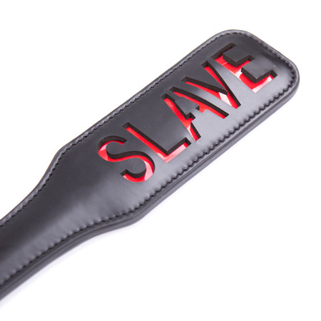 Leather-like spanker with the word 'slave' inscripted