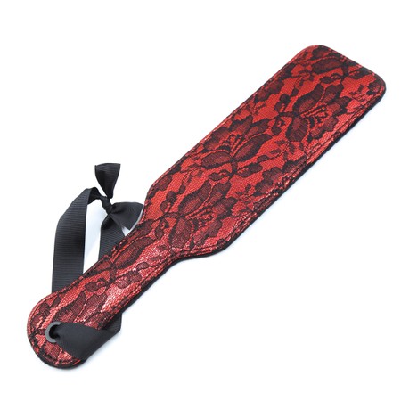 Red spanker with black lace embellishment and ribbon