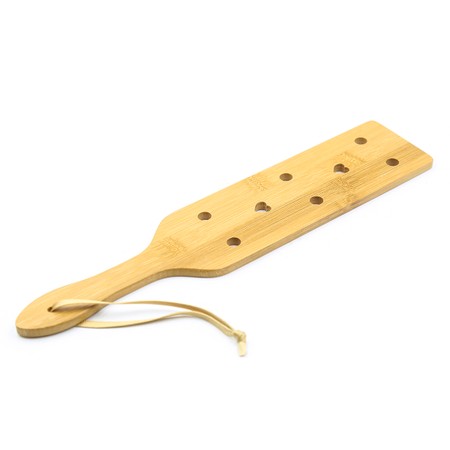 Perforated wooden paddle for whipping