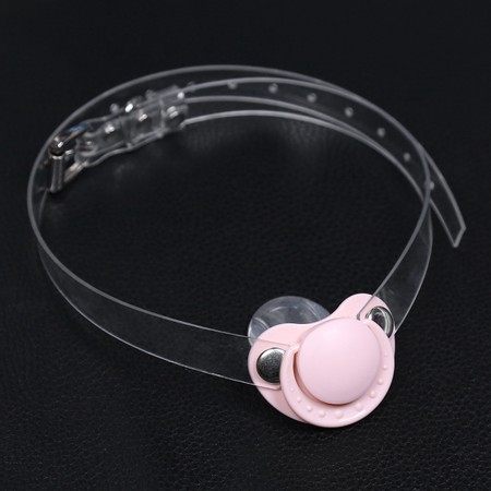 Gag in the shape of a pink pacifier with a transparent strap